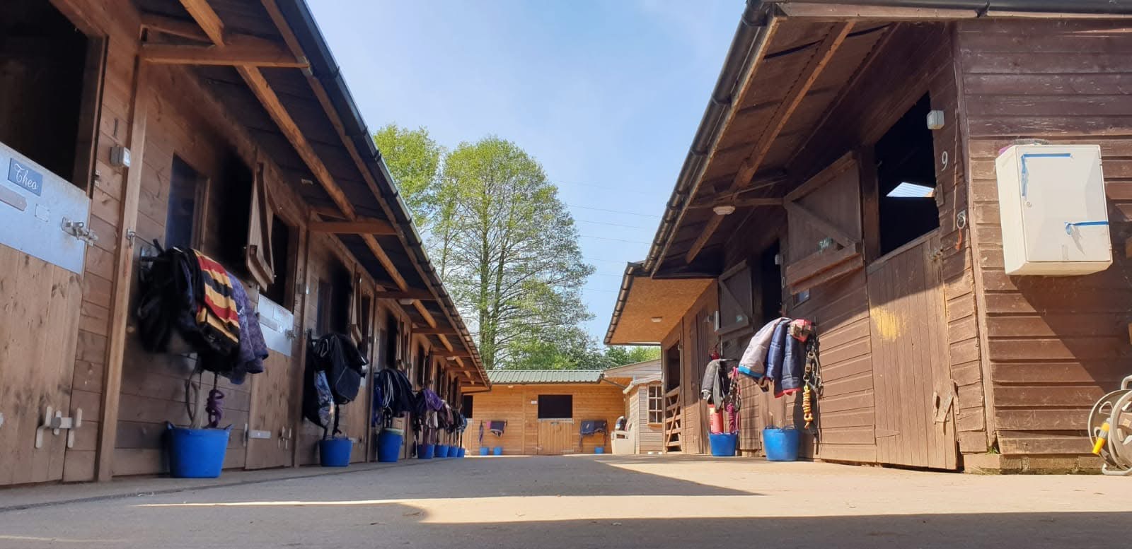 Traditional red-brick stable yard with cobblestone floor