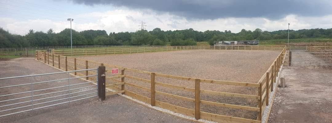 Green paddocks with post and rail fencing